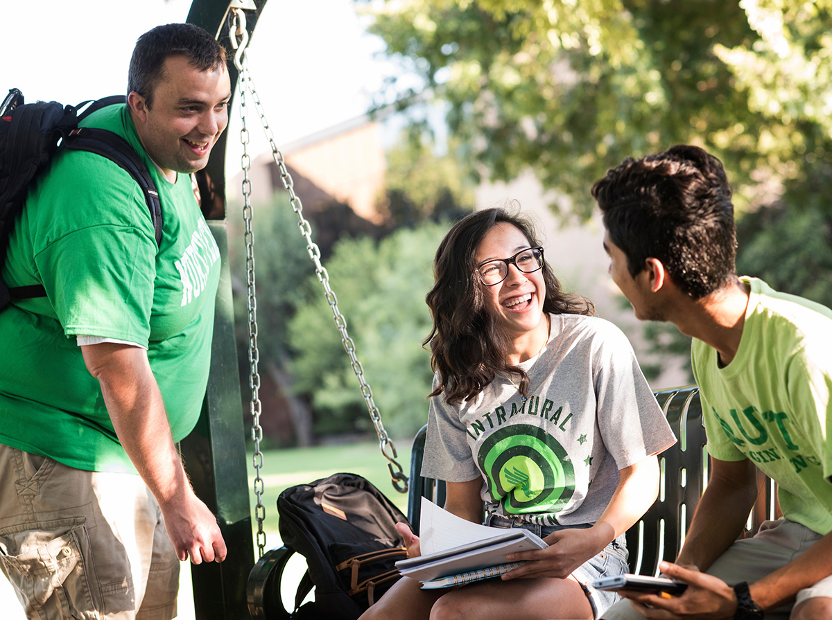 Three UNT students talking to each other at Discovery Park